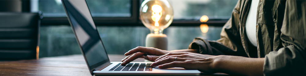 Woman typing on laptop keyboard
